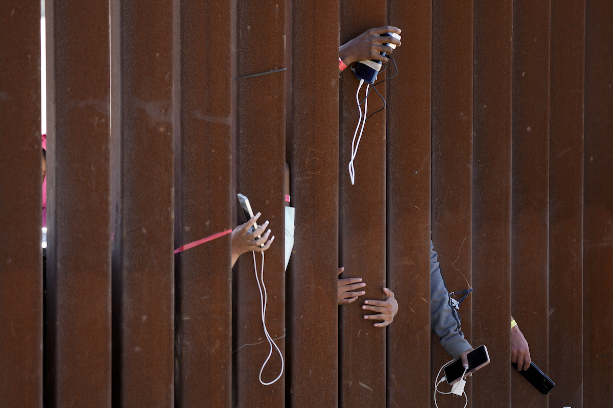 SPANISH: Border with hands holding phones