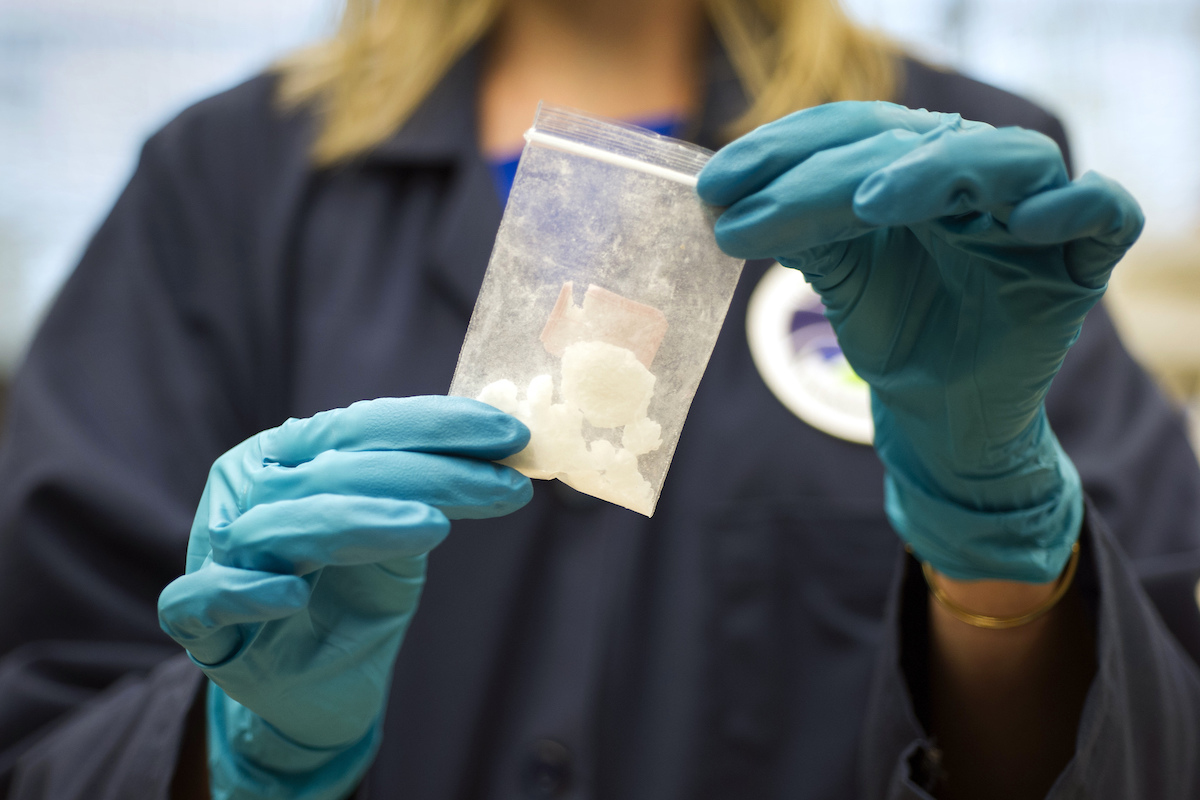 gloved hands holding a bag of fentanyl in Sterling, Va., 8-9-2016