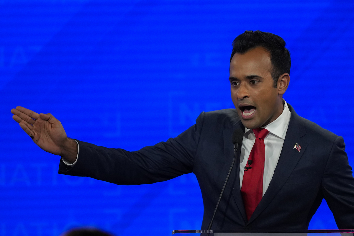 Ramaswamy GOP debate looking to one side with his hand out, 12-6-2023