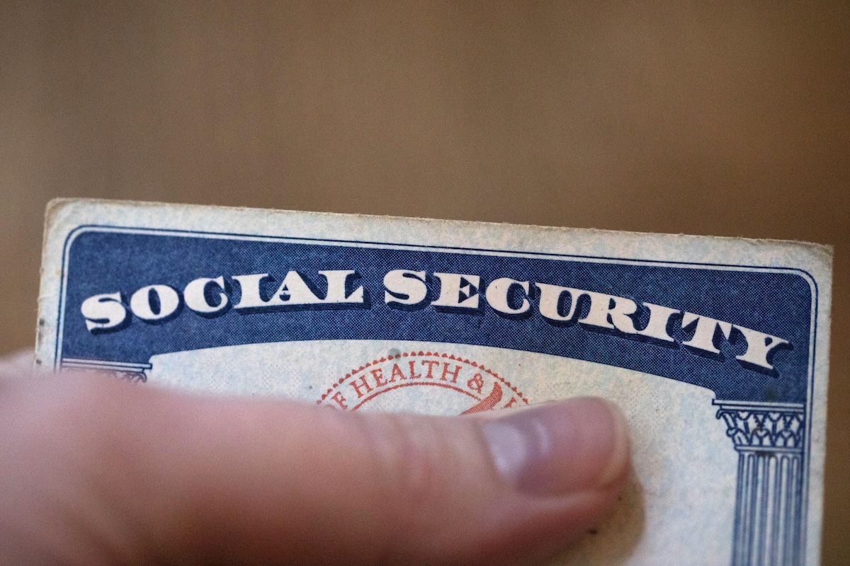 Social Security card with thumb covering the number
