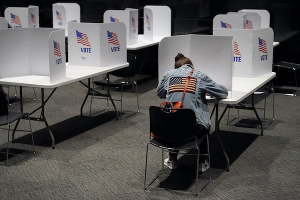 woman sitting down to vote