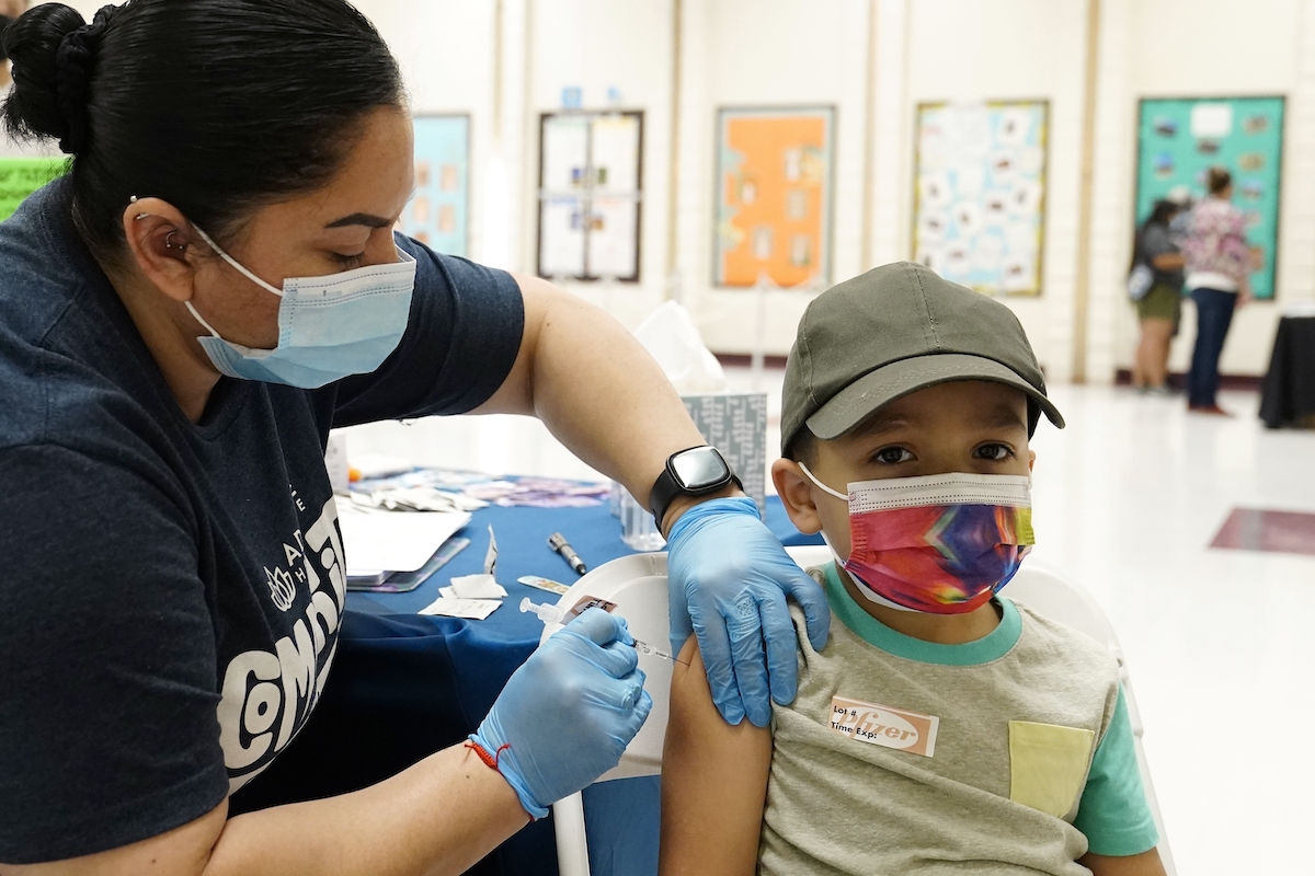 Nurse gives a little boy the Pfizer vaccine