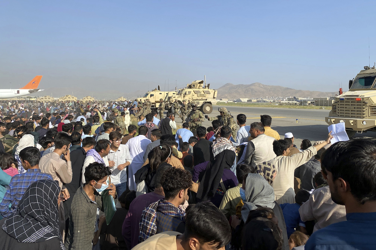 Afghans on tarmac at airport