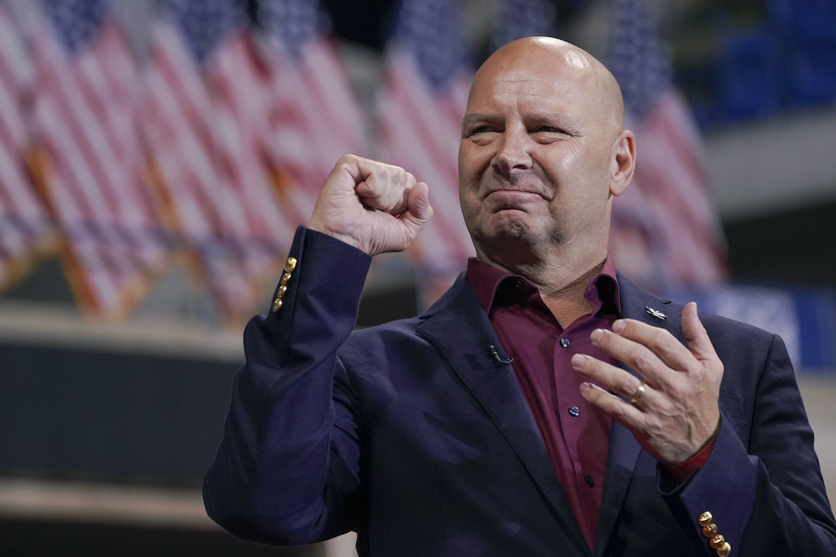 Doug Mastriano fist pump in front of flags 9-3-22