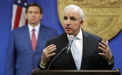 Carlos Gimenez with DeSantis in background June 2020
