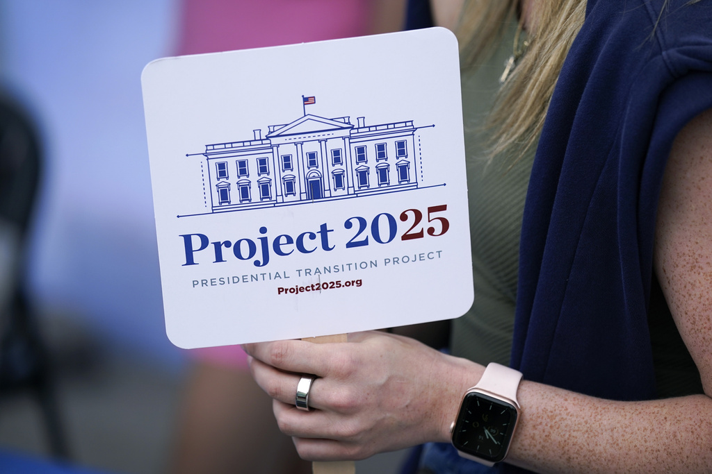 Project 2025 fan held by woman