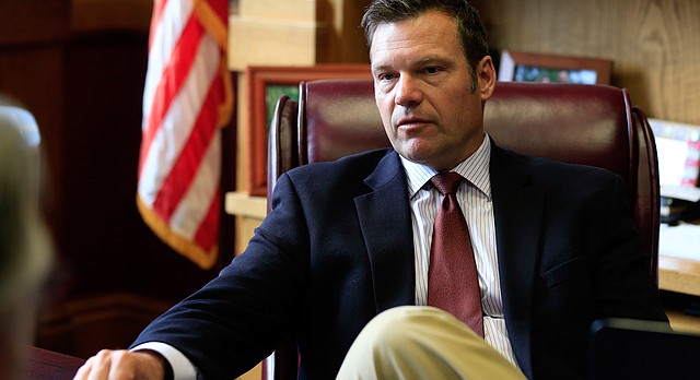 Kansas Secretary of State Kris Kobach at desk