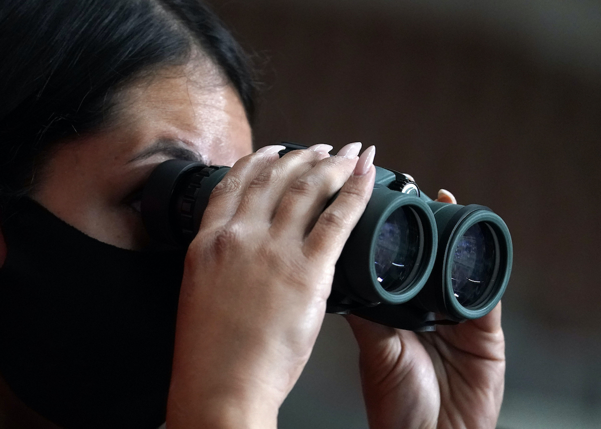 Reporter watching Maricopa audit with binoculars 4-29-21