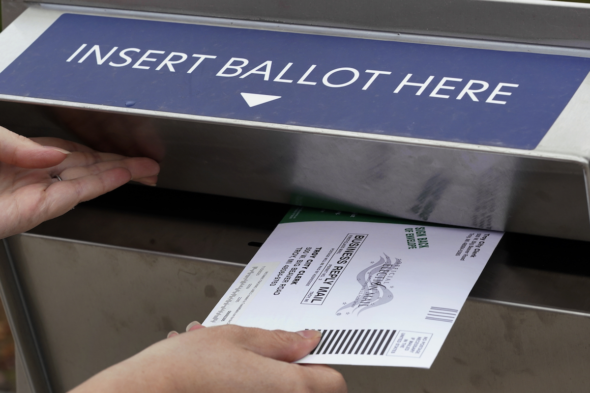 Michigan voter puts ballot into drop box 10-15-2020