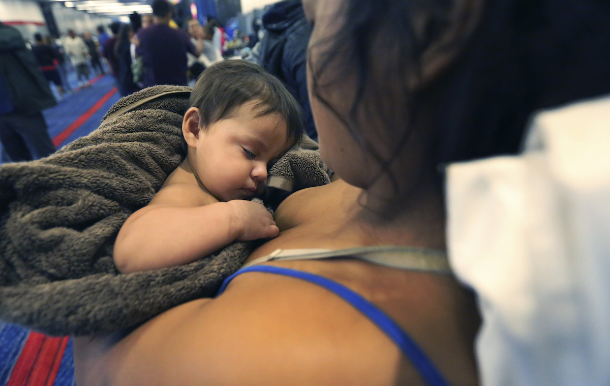 Woman holding baby to her chest in Harvey