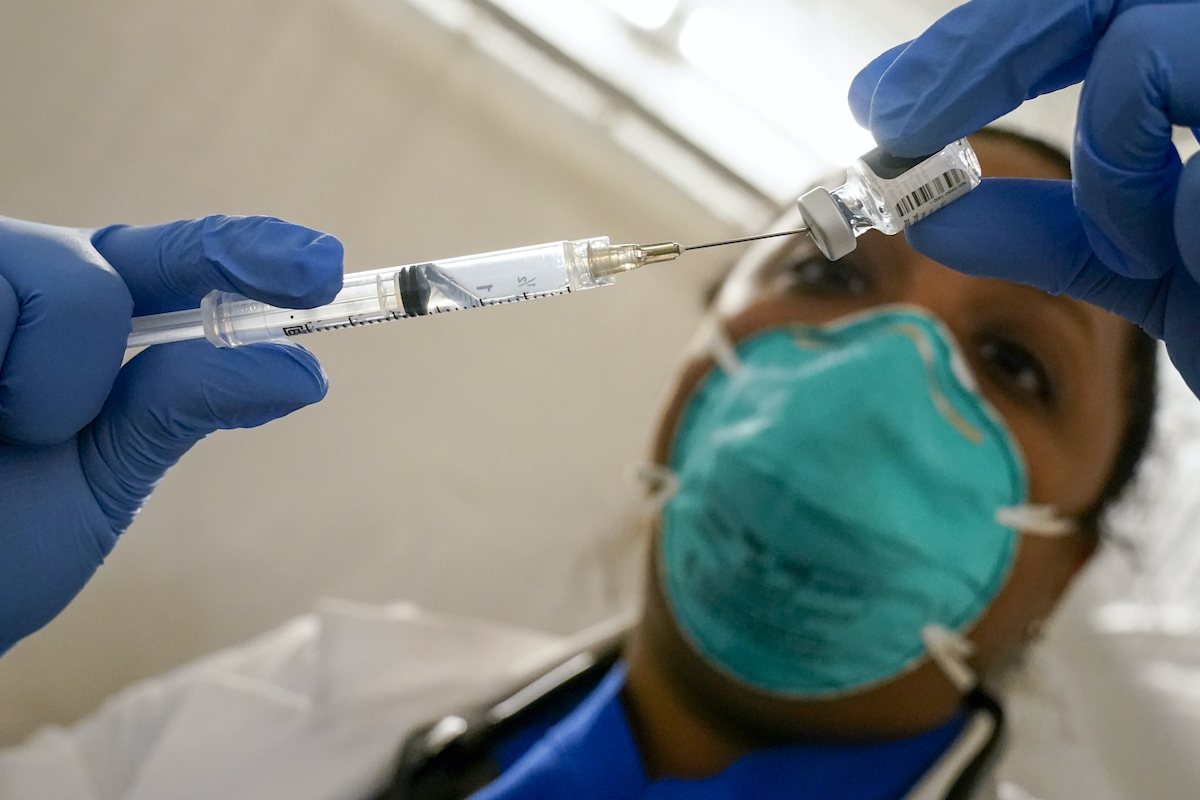 Nurse extracts pfizer vaccine