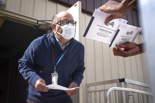 Election worker examines Philadelphia ballot October 2020