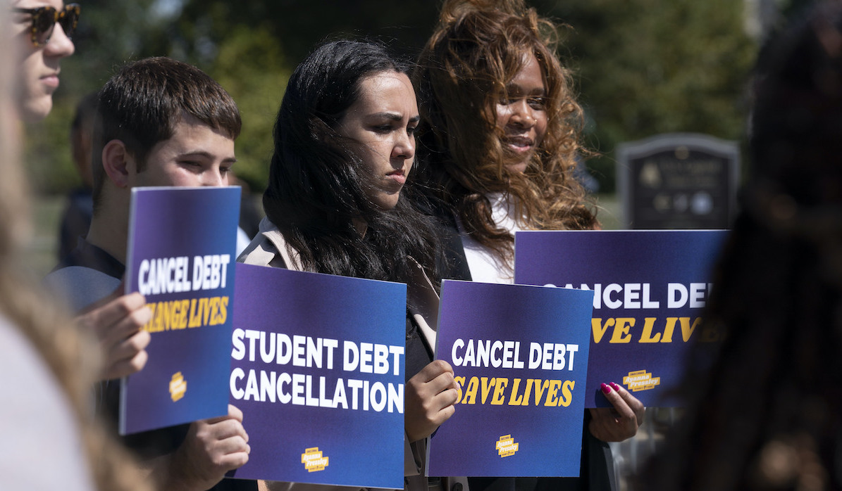 Activists with signs for student debt relief Capitol Hill DC 9-29-22