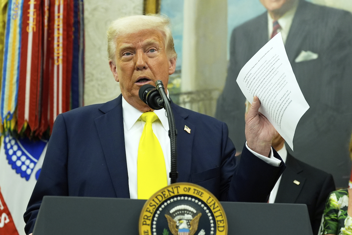 Trump holds document about Abrego Garcia 4-18-25