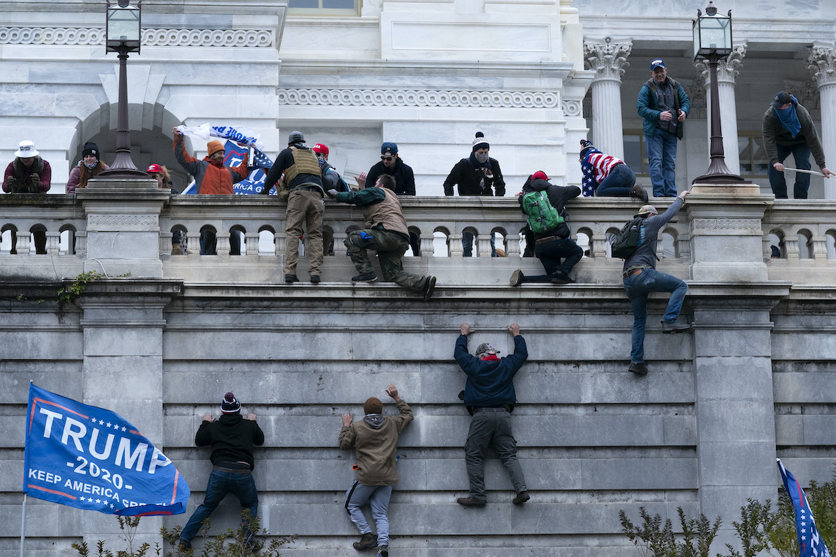 Trump supporters climb Capitol wall