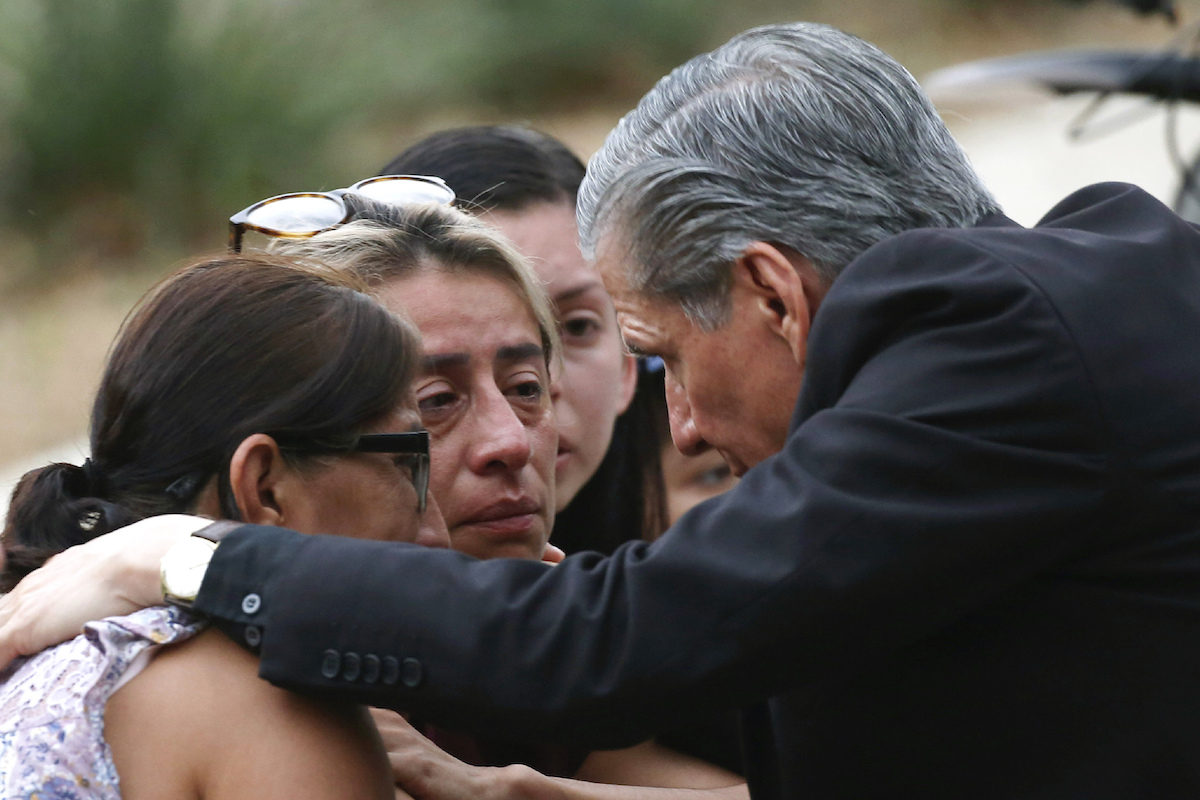 Uvalde, Texas, mass shooting, archbishop of San Antonio comforts people outside the Civic Center