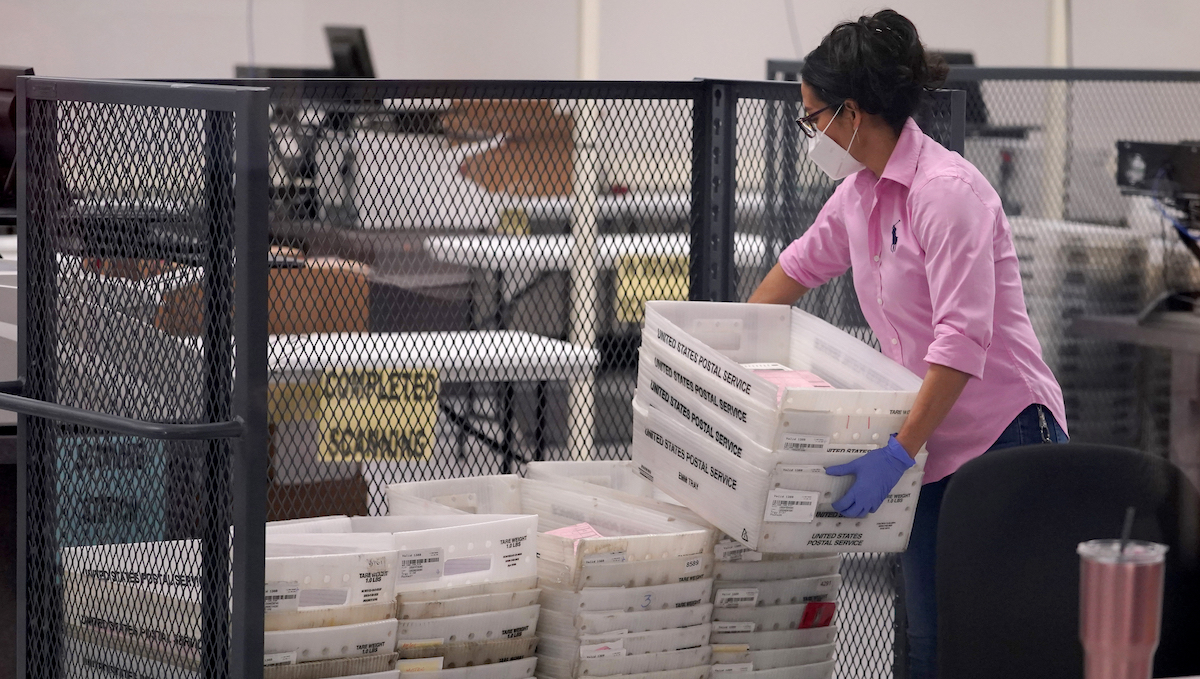 Worker carries ballots in Phoenix, Nov. 10, 2022