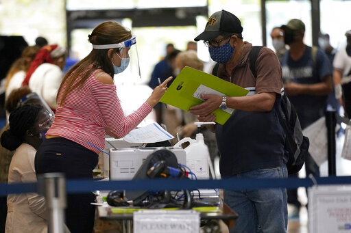 Miami election worker with voter Oct 2020