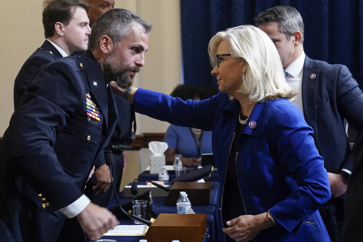 Liz Cheney greets law enforcement officer at hearing