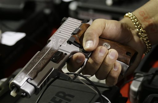 Handgun gripped by hand