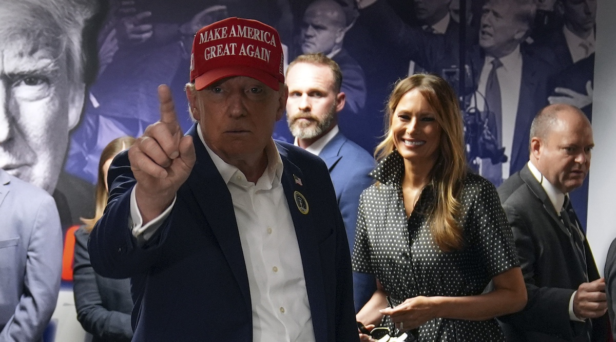 Donald Trump points with Melania Trump alongside in Palm Beach, Fla., 11-5-2024