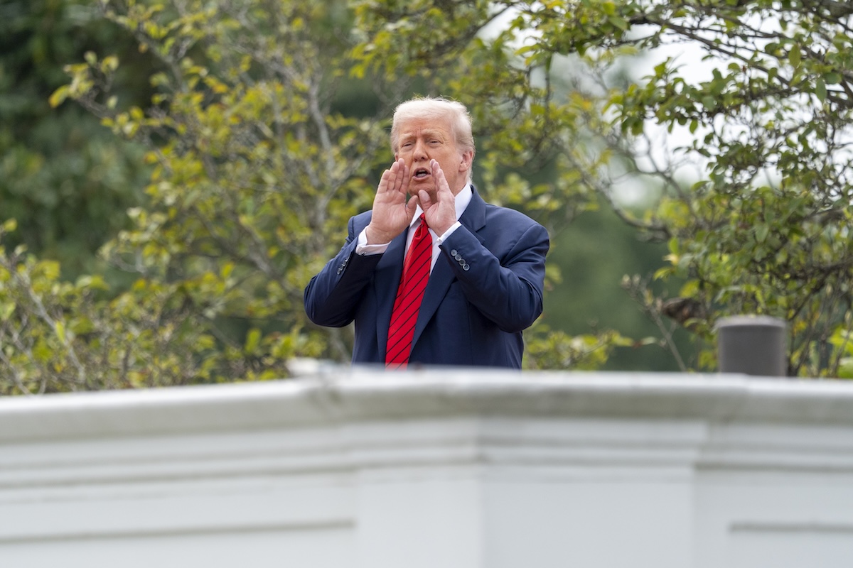 Donald Trump shouting at reporters from colonnade