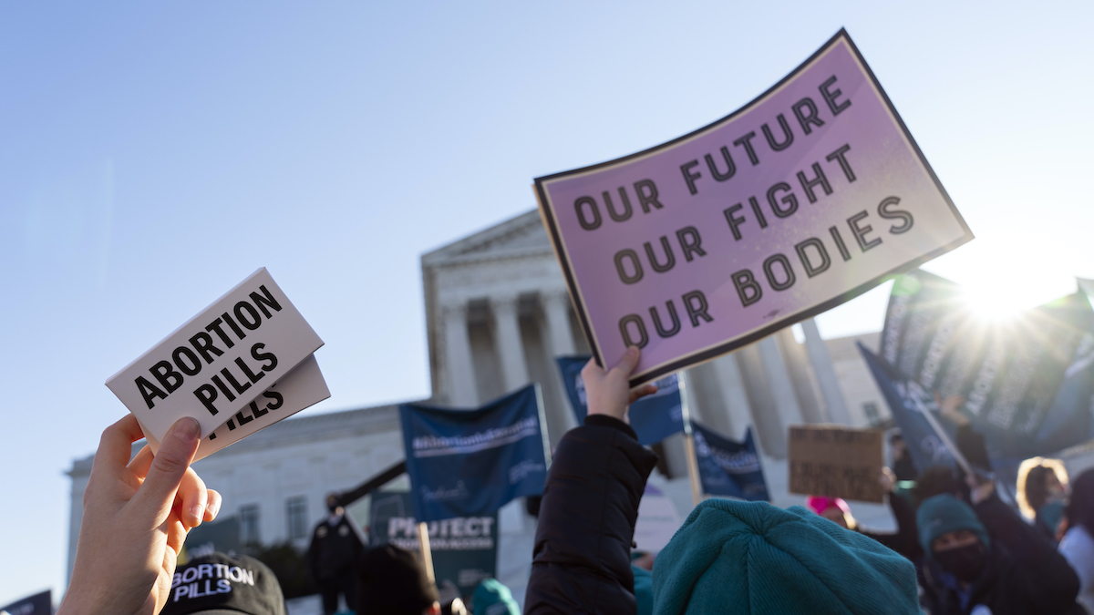 Abortion pills protest signs