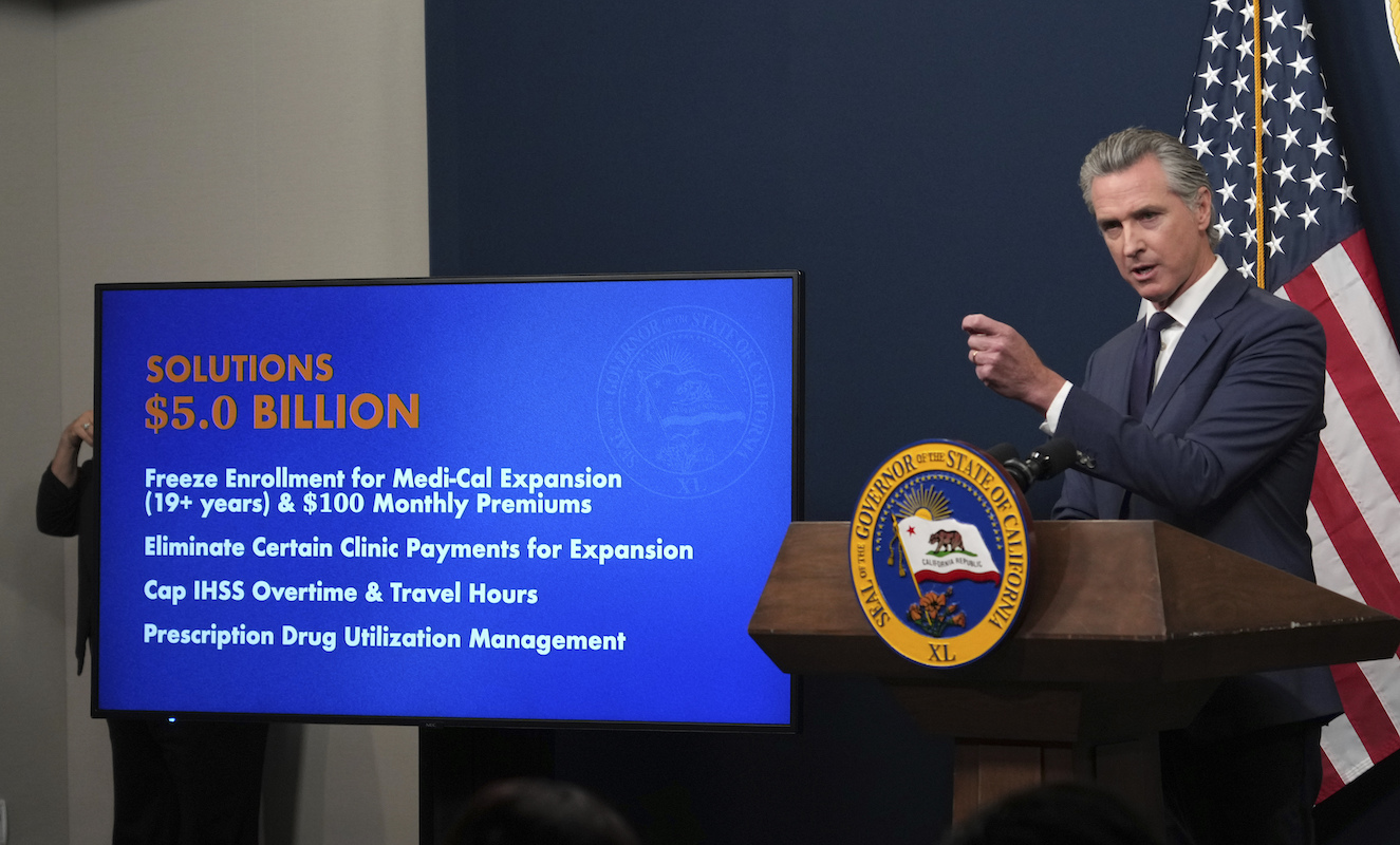 Gov. Gavin Newsom with Medi-Cal cuts sign 5-14-25