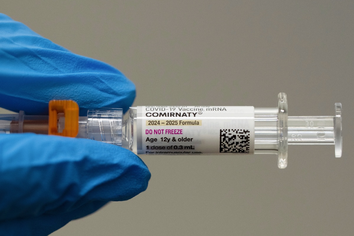 Pharmacist holds COVID-19 vaccine 07-24-2025