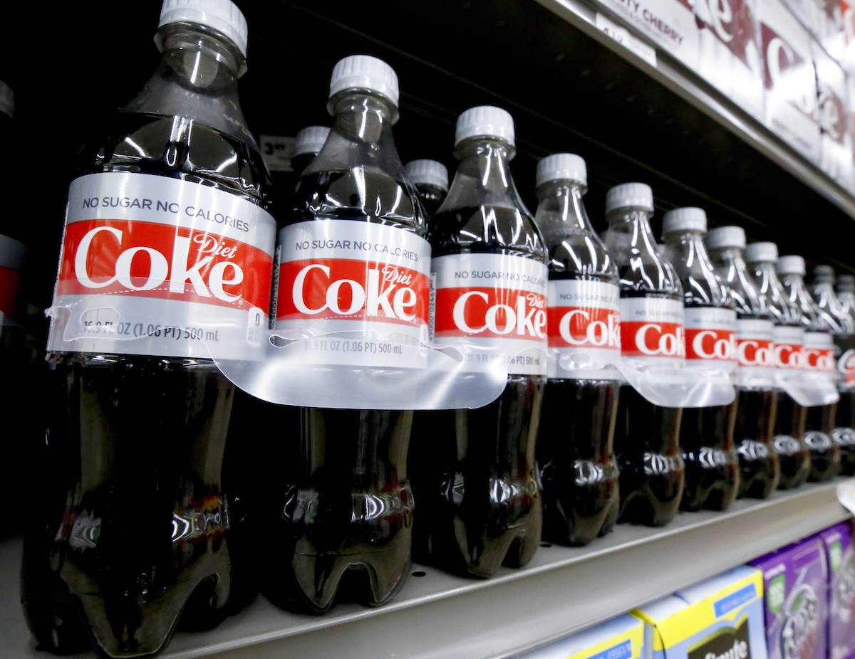 Plastic bottles of diet coke on store shelf