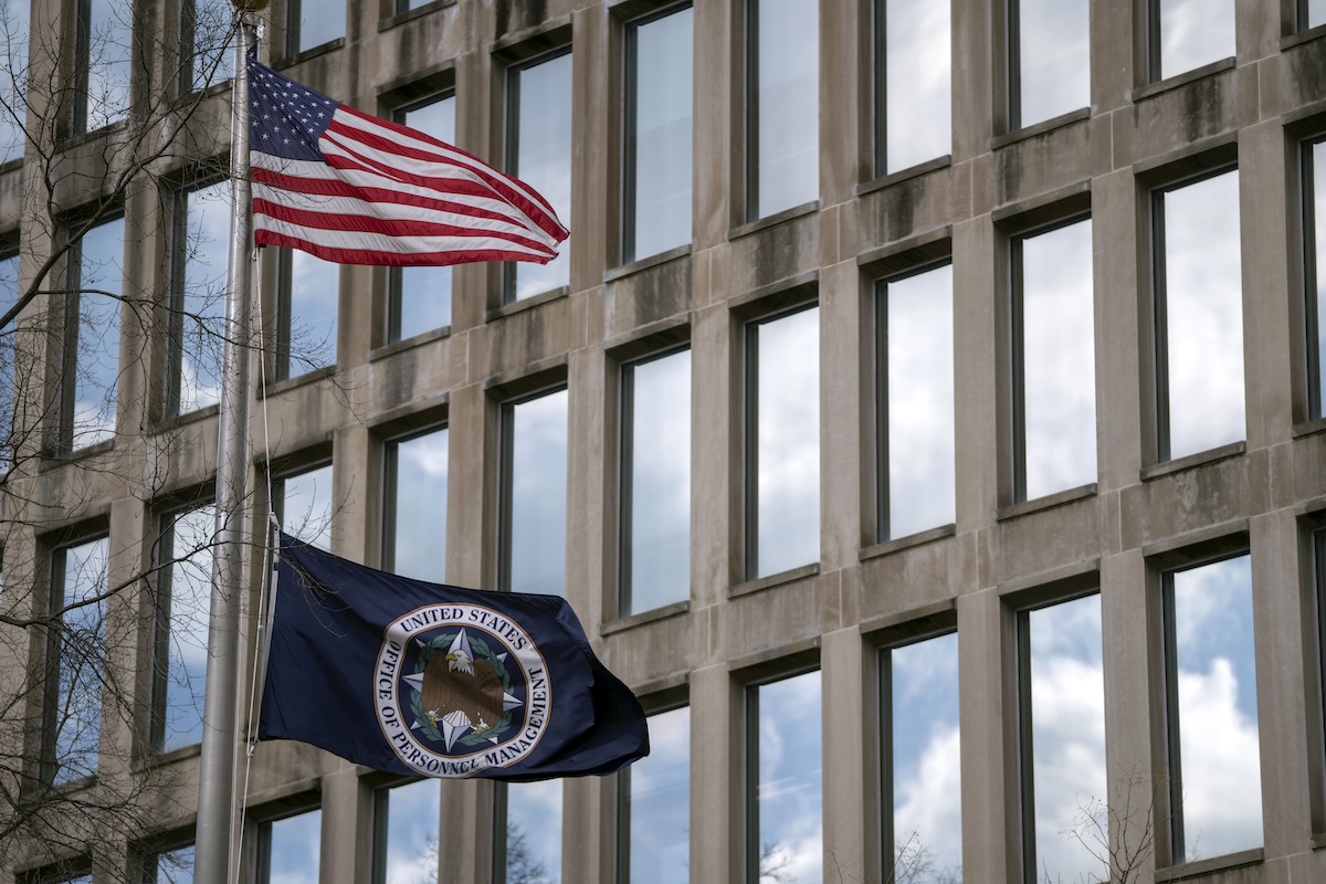 Office of Personnel Management facade with flags