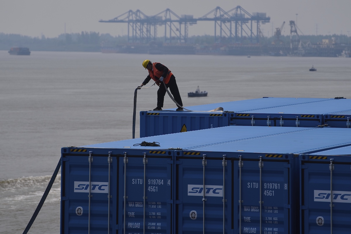 Worker unloads cargo at a Chinese port