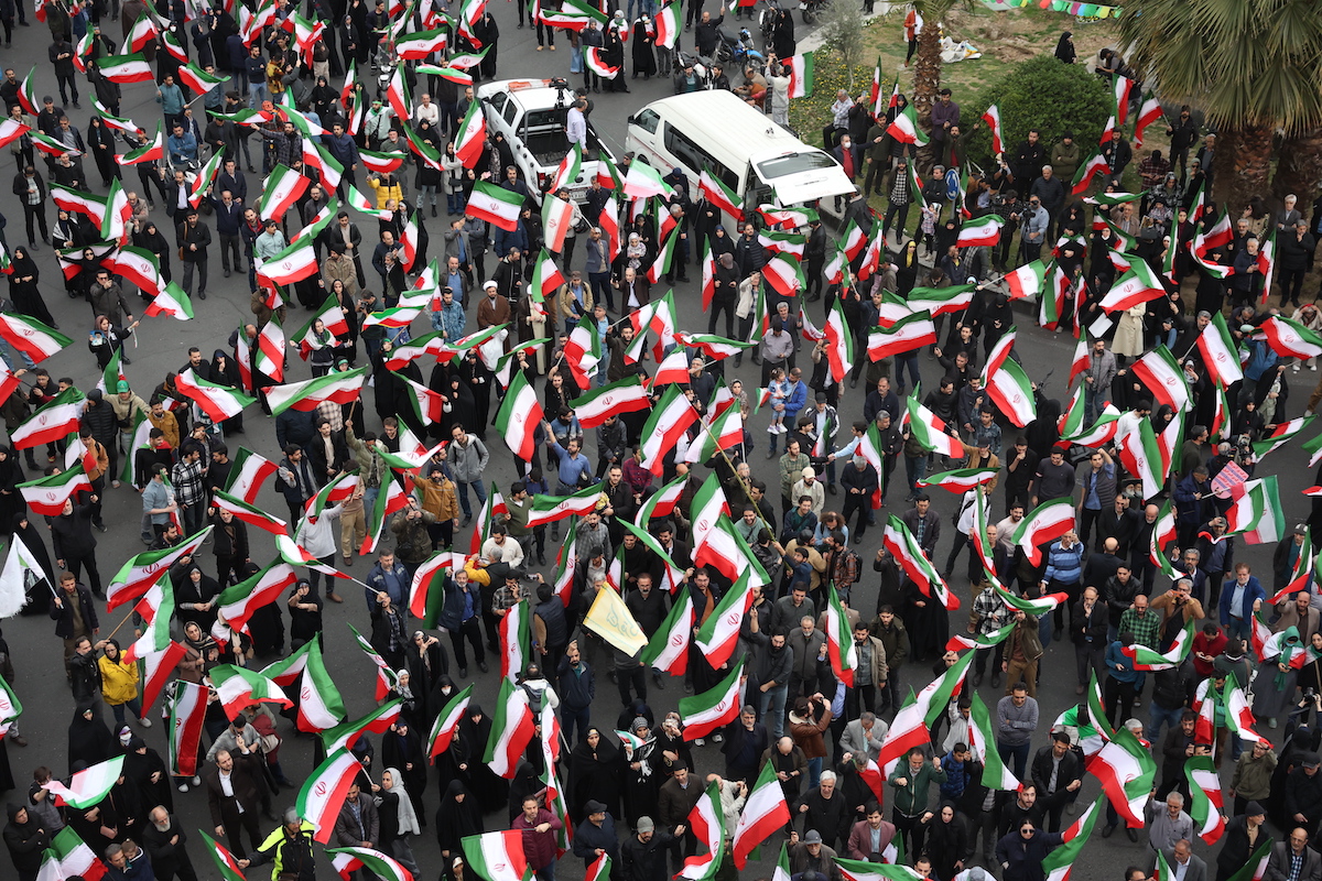 Iranian demonstrators wave flags 2-28-26