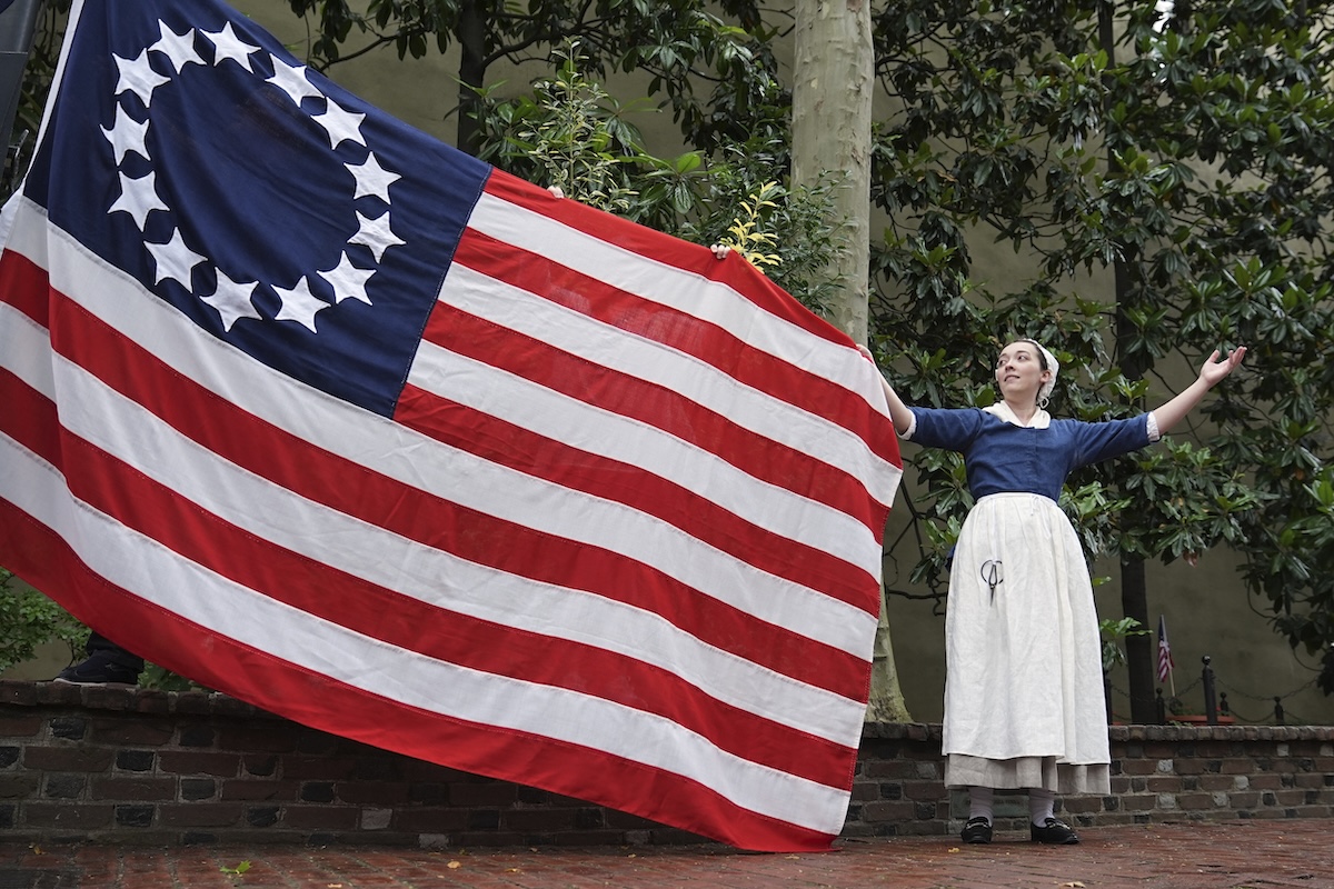 Betsy Ross impersonator holds flag
