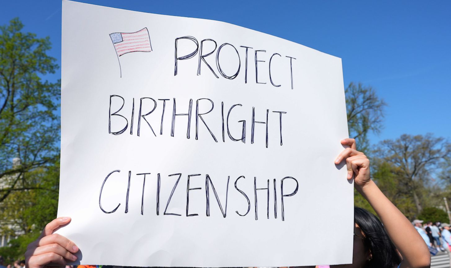Person holding sign of birthright citizenship 04-01-26